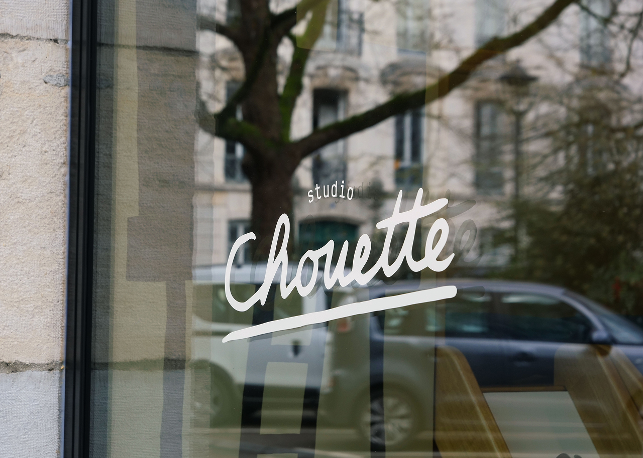 logotype sur les vitres de la boutique studio chouette à Besançon